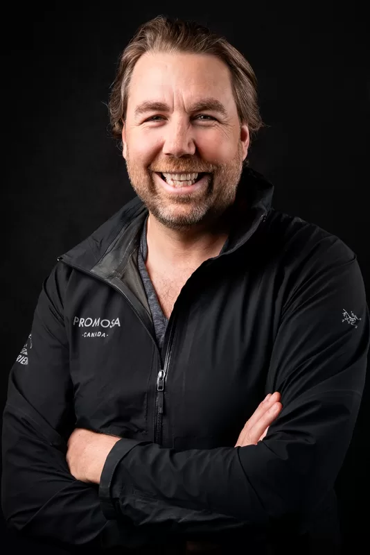 Promosa team member in a branded black jacket